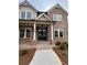 A close-up of a home's front entrance and walkway, showing a brick facade, porch and sidelights at 4125 Sierra Vista Cir, Cumming, GA 30040