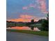 Scenic view of a sunset over a calm lake in a beautiful, serene neighborhood at 4125 Sierra Vista Cir, Cumming, GA 30040