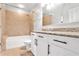 Bathroom with tub, shower, granite countertops and white cabinets, offering a clean aesthetic at 44 Peachtree Ne Pl # 1929, Atlanta, GA 30309