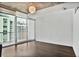 Bright bedroom with hardwood floors, modern light fixture, and cityscape views at 44 Peachtree Ne Pl # 1929, Atlanta, GA 30309