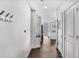Hallway view to kitchen featuring hardwood floors, white walls, and stainless appliances at 44 Peachtree Ne Pl # 1929, Atlanta, GA 30309