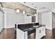 Contemporary kitchen island with granite countertops, stainless steel dishwasher, and stylish pendant lighting at 44 Peachtree Ne Pl # 1929, Atlanta, GA 30309