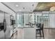 Contemporary kitchen with stainless steel appliances, marble countertops, and cityscape views at 44 Peachtree Ne Pl # 1929, Atlanta, GA 30309