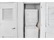 Convenient laundry room featuring a stacked washer and dryer unit at 44 Peachtree Ne Pl # 1929, Atlanta, GA 30309