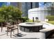 Inviting outdoor lounge with a fire pit, comfortable seating, and lush landscaping for relaxing and socializing at 44 Peachtree Ne Pl # 1929, Atlanta, GA 30309