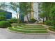 Beautifully landscaped outdoor area with tiered seating, mature trees, and grilling stations at 44 Peachtree Ne Pl # 1929, Atlanta, GA 30309
