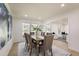 Open-concept dining room with a long wood table, six chairs, and seamless access to the living area at 605 Patrick Ne Pl, Sandy Springs, GA 30328
