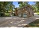 A brick home with an attached garage and driveway, framed by a well-maintained yard at 605 Patrick Ne Pl, Sandy Springs, GA 30328