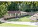 Beautiful home with mature landscaping, showcasing a brick facade and expansive front yard at 605 Patrick Ne Pl, Sandy Springs, GA 30328
