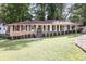 Charming brick home featuring a well-manicured lawn and classic shutters, set amidst lush greenery at 605 Patrick Ne Pl, Sandy Springs, GA 30328