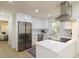 Stainless steel appliances and white cabinets complement the modern kitchen's bright design at 605 Patrick Ne Pl, Sandy Springs, GA 30328