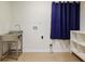 This laundry room includes a stainless-steel sink and built-in shelving at 605 Patrick Ne Pl, Sandy Springs, GA 30328
