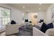 Bright living room with four armchairs, a stylish rug, and ample natural light from large windows at 605 Patrick Ne Pl, Sandy Springs, GA 30328