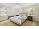 Comfortable bedroom with a queen-sized bed, neutral tones, and natural light from two windows at 605 Patrick Ne Pl, Sandy Springs, GA 30328