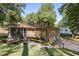 Brick home showcasing an outdoor bench, and backyard, complemented by mature trees at 605 Patrick Ne Pl, Sandy Springs, GA 30328