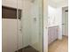 Modern bathroom featuring a glass-enclosed shower with tiled walls and a view of the vanity area at 605 Patrick Ne Pl, Sandy Springs, GA 30328