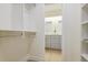 Spacious walk-in closet with custom shelving and storage solutions leading to the bathroom at 605 Patrick Ne Pl, Sandy Springs, GA 30328