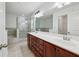 Bright bathroom with double sink vanity, soaking tub, and glass shower with gray-toned tile at 655 Mead Se St # 58, Atlanta, GA 30312