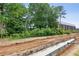 New construction site showing foundation work and surrounding greenery at 655 Mead Se St # 58, Atlanta, GA 30312