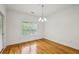 Bright dining room features hardwood floors, modern chandelier, and natural light from a large window at 655 Mead Se St # 58, Atlanta, GA 30312