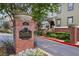 Brick signage for Oldfield at Grant Park, lush landscaping, and attractive townhome exteriors at 655 Mead Se St # 58, Atlanta, GA 30312