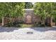 Unique stone facade with arched door and detailed brick driveway, nestled among mature trees at 655 Mead Se St # 58, Atlanta, GA 30312