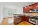 Modern kitchen with stainless steel appliances, granite countertops, and wood cabinets at 655 Mead Se St # 58, Atlanta, GA 30312
