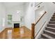 Sunlit living room boasts a fireplace, staircase access, and soaring ceilings for an airy atmosphere at 655 Mead Se St # 58, Atlanta, GA 30312