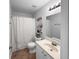 Bright bathroom features neutral paint and floors, tub and shower combination, and modern vanity at 902 Ashton Oak Cir, Stone Mountain, GA 30083
