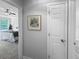View of a bedroom featuring neutral walls and carpet, with a ceiling fan and natural light from the window at 902 Ashton Oak Cir, Stone Mountain, GA 30083