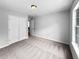 View of the bedroom featuring neutral walls and carpet, a window and a double door closet at 902 Ashton Oak Cir, Stone Mountain, GA 30083