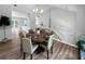 Bright dining area features wood floors, modern chandelier, and a table set for eight, ideal for entertaining at 902 Ashton Oak Cir, Stone Mountain, GA 30083