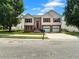 Charming two-story home with a well-manicured lawn, two-car garage, and red door, creating a welcoming curb appeal at 902 Ashton Oak Cir, Stone Mountain, GA 30083