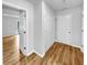 Hallway featuring wood-look floors, neutral paint and trim, with multiple doors and closets at 902 Ashton Oak Cir, Stone Mountain, GA 30083