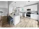 Modern kitchen with stainless steel appliances, granite countertops, a central island, and an eat in bar at 902 Ashton Oak Cir, Stone Mountain, GA 30083