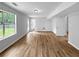 Open concept living room featuring wood-look floors, neutral paint, natural light and a glass door exit at 902 Ashton Oak Cir, Stone Mountain, GA 30083