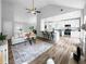 Open living space with an open kitchen, bar seating, hardwood floors, a modern sofa, and neutral decor at 902 Ashton Oak Cir, Stone Mountain, GA 30083
