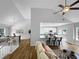 Open living space with hardwood floors, bar seating, open access to kitchen, and a view of the dining room at 902 Ashton Oak Cir, Stone Mountain, GA 30083