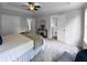 Spacious main bedroom with plush carpeting, double closets, and a decorative ceiling fan, providing comfort and style at 902 Ashton Oak Cir, Stone Mountain, GA 30083
