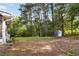 Large, sunny backyard featuring a small shed and bordering woods at 2142 Graystone Pkwy, Grayson, GA 30017