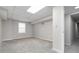 Spacious basement featuring neutral paint and plush gray carpet, perfect for storage or a recreation area at 2142 Graystone Pkwy, Grayson, GA 30017