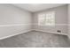 Bright bedroom with neutral walls, carpet and large window offering abundant natural light at 2142 Graystone Pkwy, Grayson, GA 30017