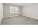 Bedroom with neutral walls, carpet, and a window offering ample natural light at 2142 Graystone Pkwy, Grayson, GA 30017