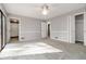 A sunlit bedroom with neutral walls and carpet, featuring access to a bathroom and closet at 2142 Graystone Pkwy, Grayson, GA 30017