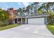 Charming home featuring blue siding, white trim, a spacious driveway, and a manicured lawn at 2142 Graystone Pkwy, Grayson, GA 30017