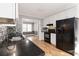 Modern kitchen with stainless steel appliances, granite countertops, and hardwood floors at 2142 Graystone Pkwy, Grayson, GA 30017