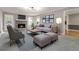 Cozy living room with a stone fireplace, neutral-toned furniture, and ample natural light at 2142 Graystone Pkwy, Grayson, GA 30017