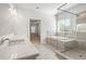 Modern bathroom with a glass shower, gray tile, and double sinks for comfort and convenience at 3293 Lions Ruby Ln, Atlanta, GA 30349