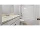Clean bathroom with white tub, toilet and vanity with countertop sink at 3293 Lions Ruby Ln, Atlanta, GA 30349