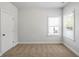 A cozy bedroom featuring two windows and neutral-colored walls at 3293 Lions Ruby Ln, Atlanta, GA 30349